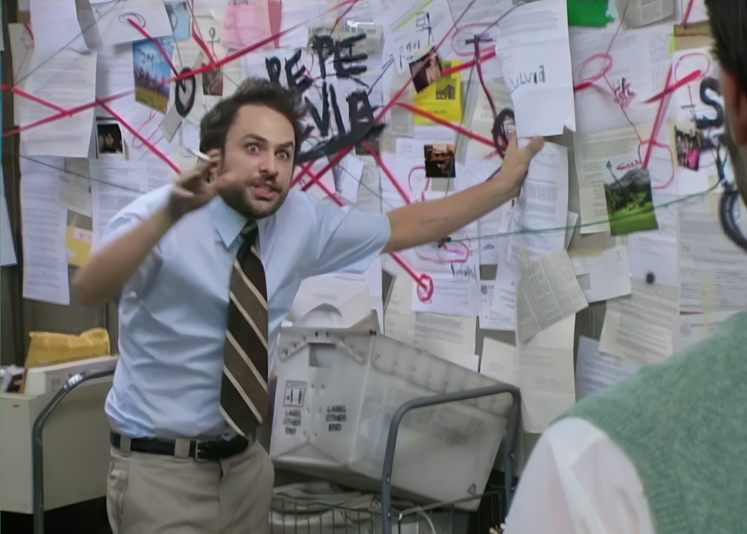 Person gesturing at a wall of papers connected by red string